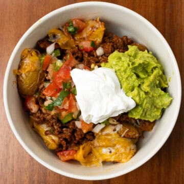 Fiesta Potato Taco Bowl finished in a bowl with guacamole and pico de Gallo