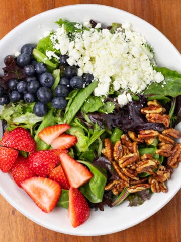 Summer Berry Salad with Feta and Candied Pecans in a bowl finished