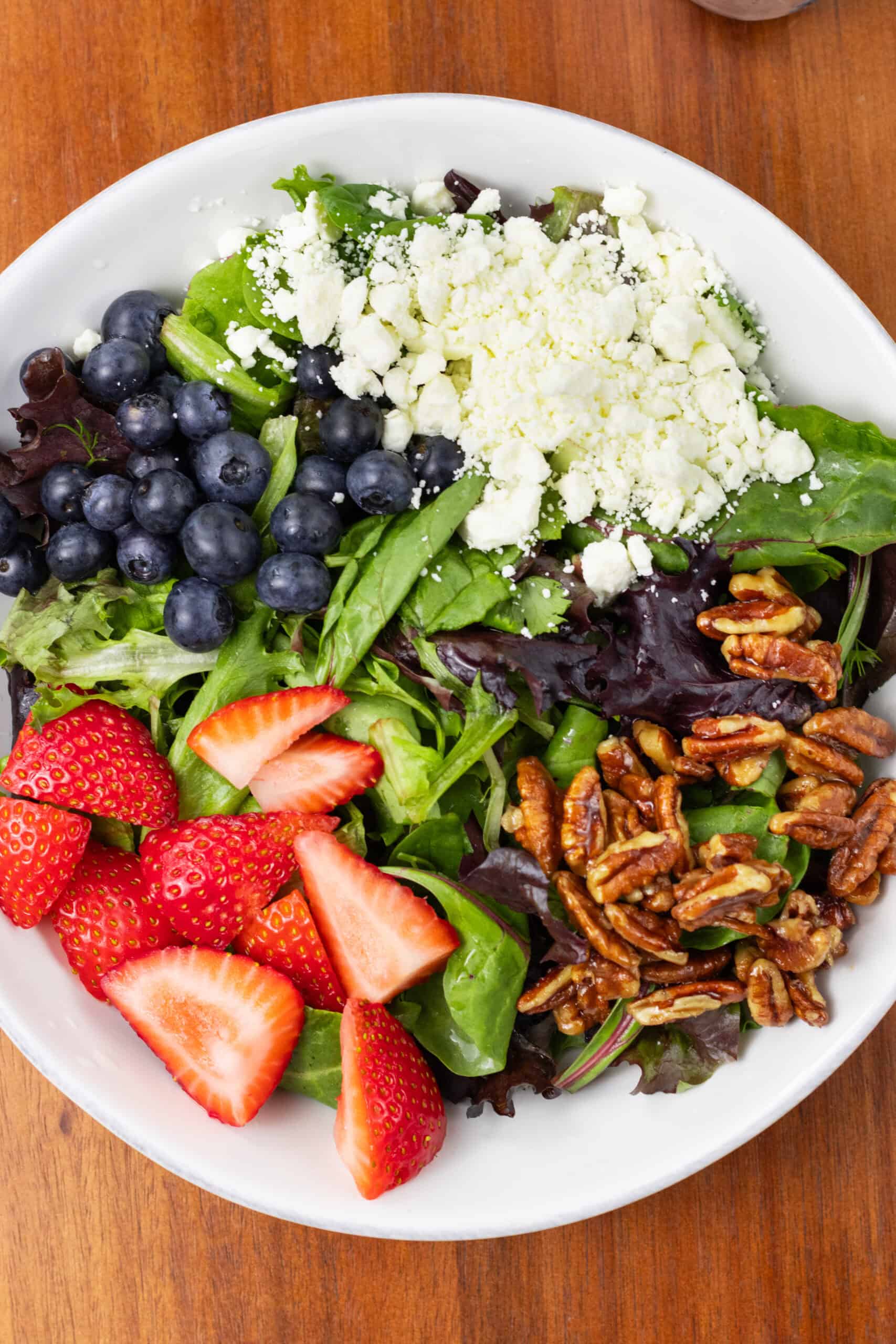 Summer Berry Salad with Feta and Candied Pecans in a bowl finished