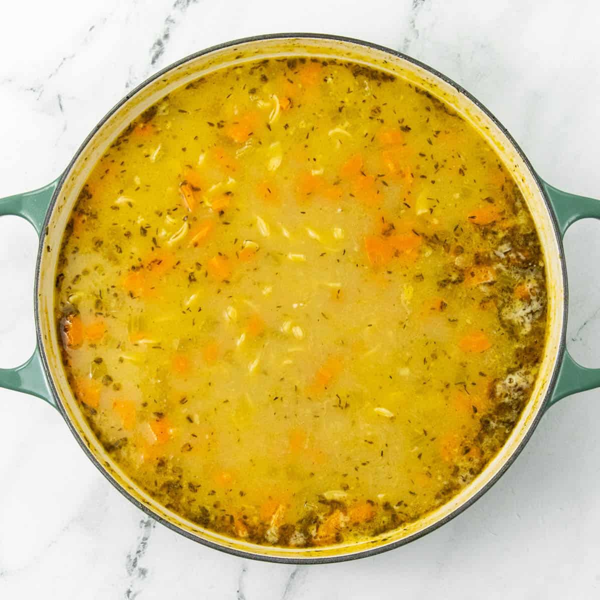 cooking noodles in broth of chicken noodle soup