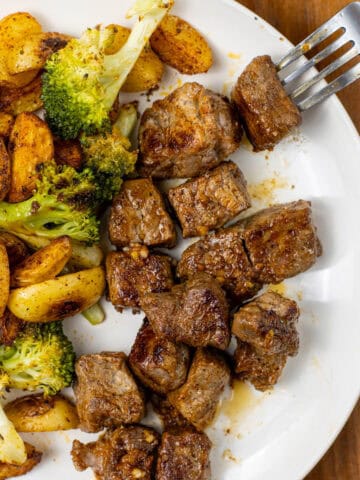 Garlic Butter Steak Bite on a plate with Potatoes and Broccoli