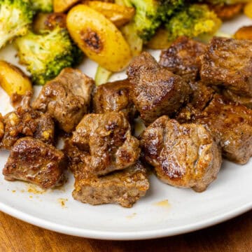Garlic Butter Steak Bite on a plate with Potatoes and Broccoli